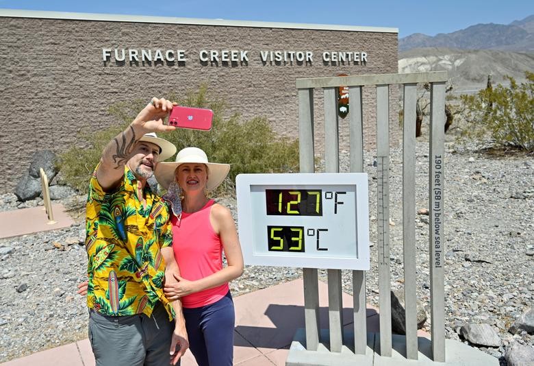 Brian David Bruns, and his wife Aurelia Bruns of Las Vegas take a selfie in front of a thermometer reading 127 degrees Fahrenheit (52 Celsius) at the Furnace Creek Visitors Center in Death Valley, California. REUTERS/David Becker  